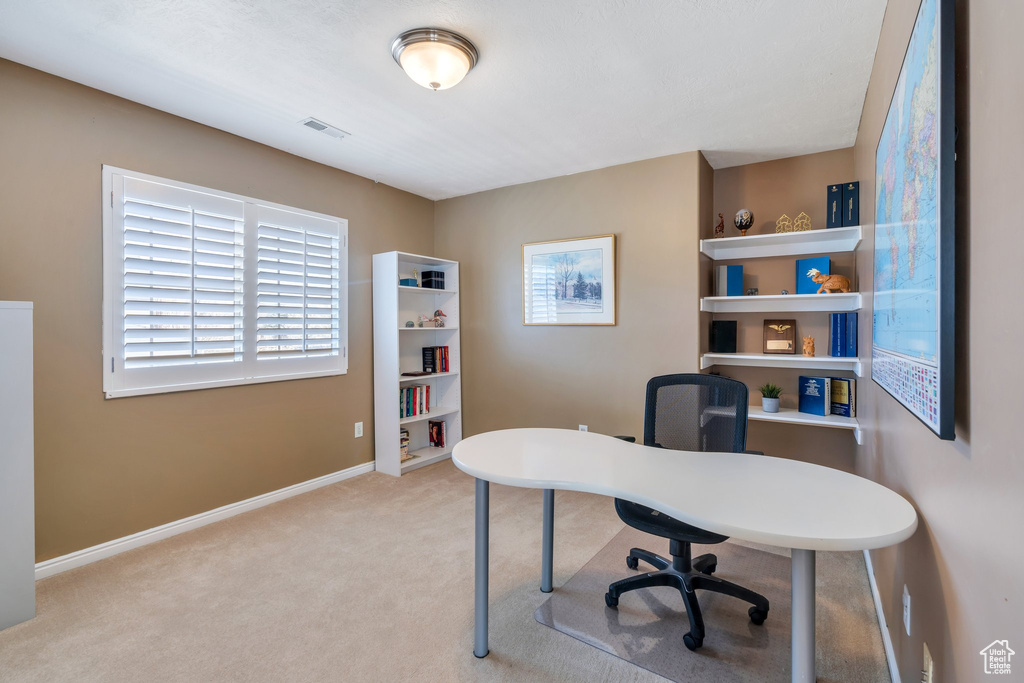 Office area featuring carpet floors and baseboards