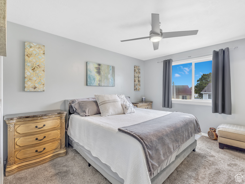 Bedroom with light carpet and ceiling fan