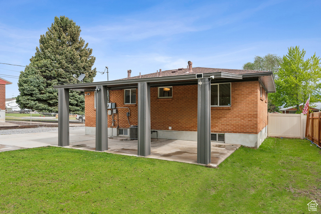 Back of property with a patio and brick siding