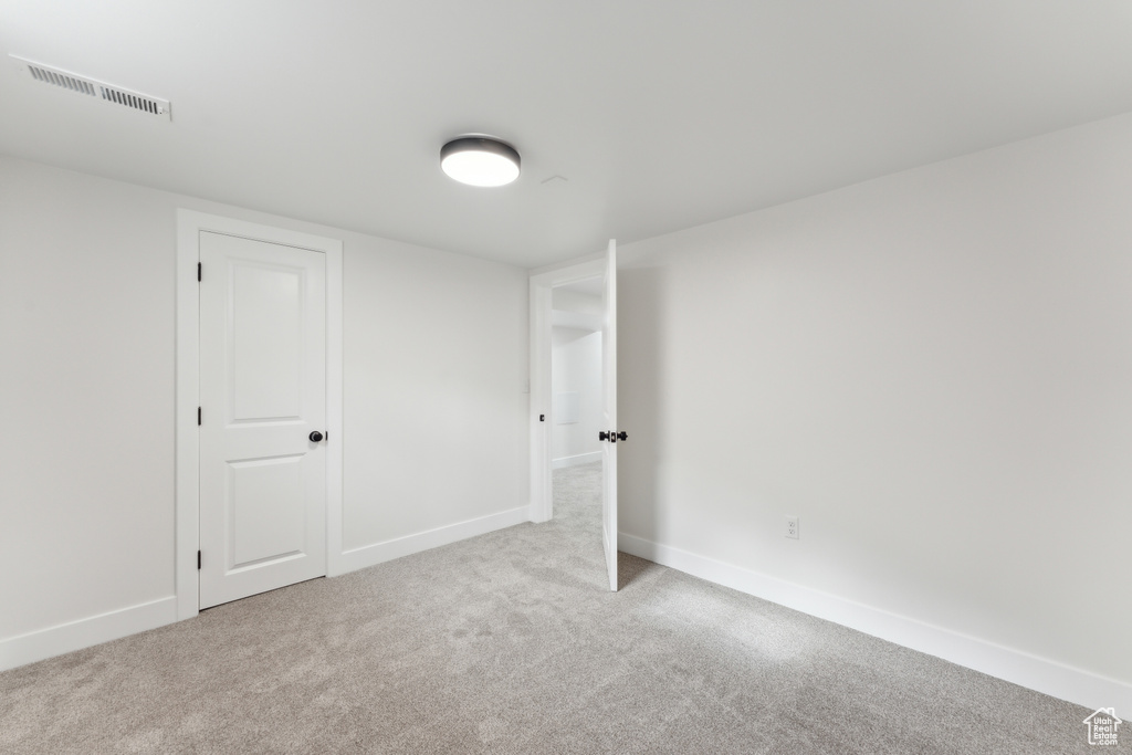 Unfurnished bedroom featuring carpet flooring and baseboards