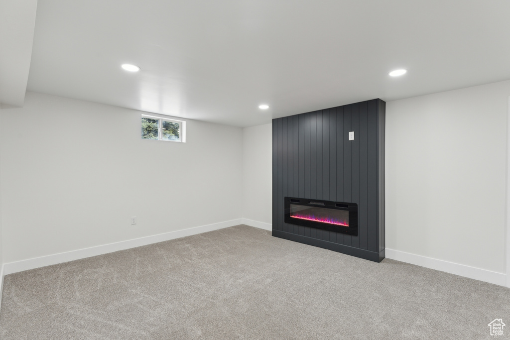 Below grade area featuring recessed lighting, carpet flooring, a large fireplace, and baseboards
