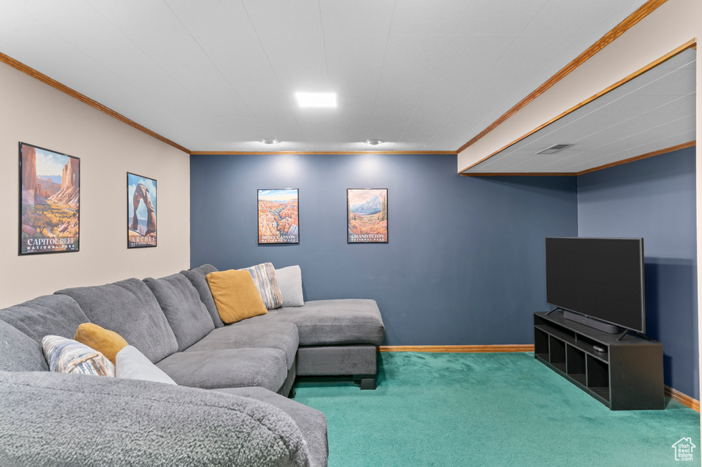 Living area with carpet floors, crown molding, and baseboards