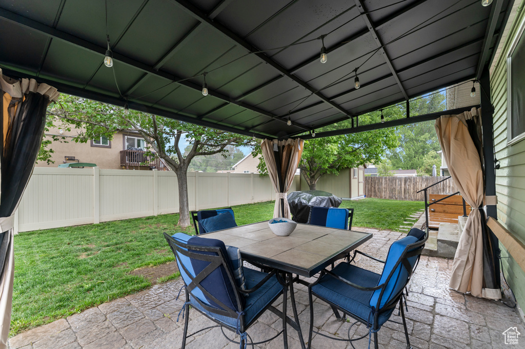 View of patio / terrace with outdoor dining area, an outdoor structure, a storage shed, and area for grilling