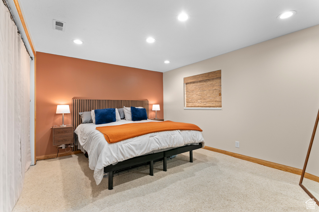Carpeted bedroom with baseboards and recessed lighting