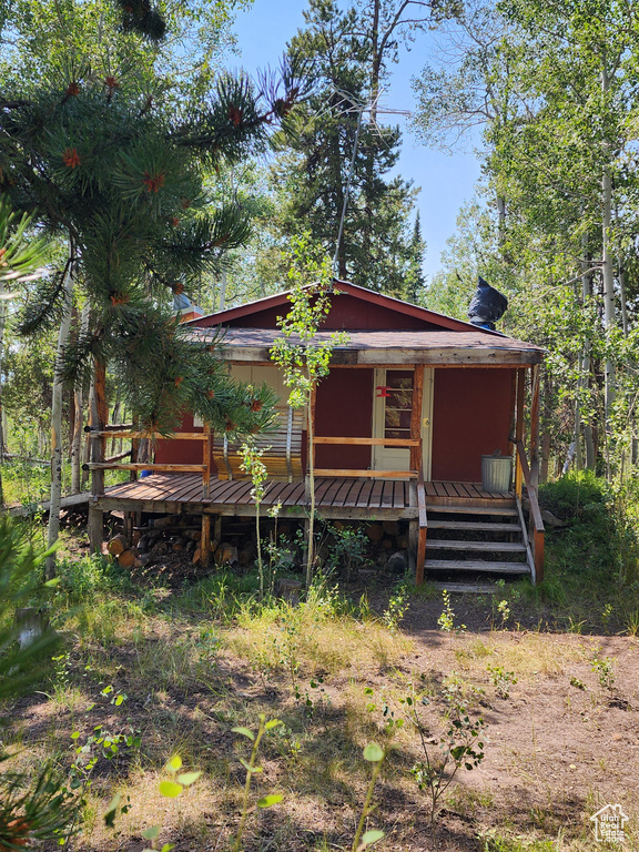 Back of house featuring covered porch