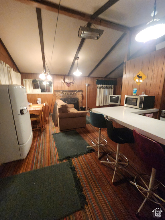 Living room with wood walls, carpet, and a fireplace