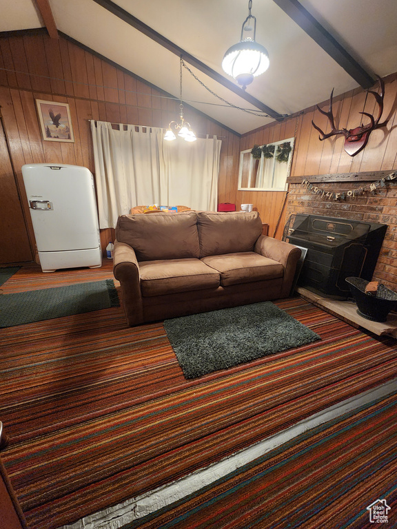 Living area featuring wooden walls and carpet floors
