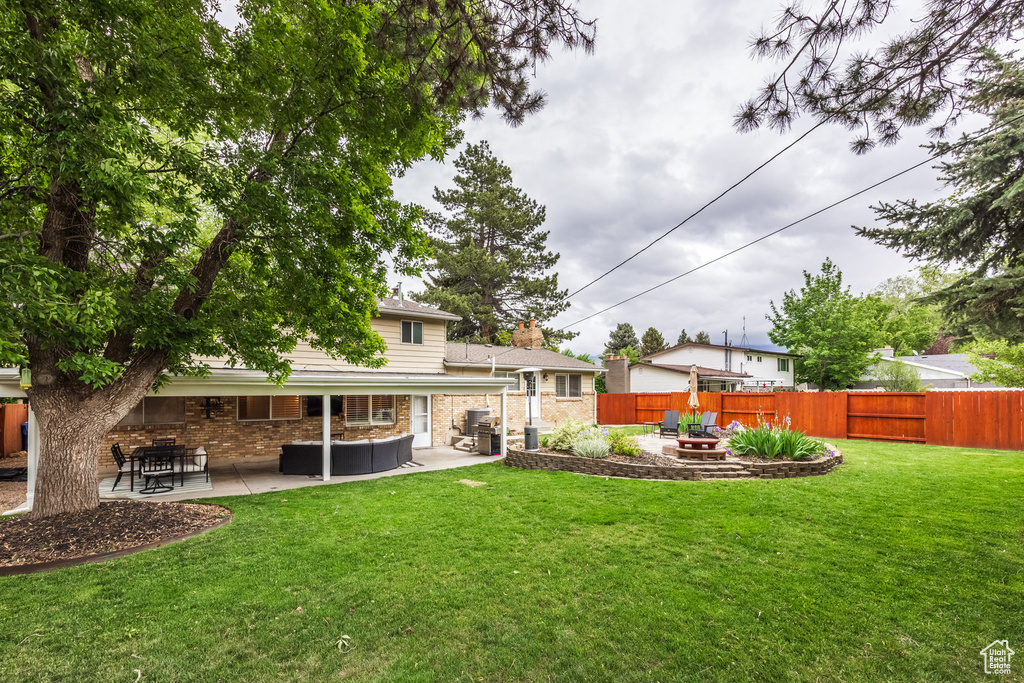Back of property featuring a patio and an outdoor living space