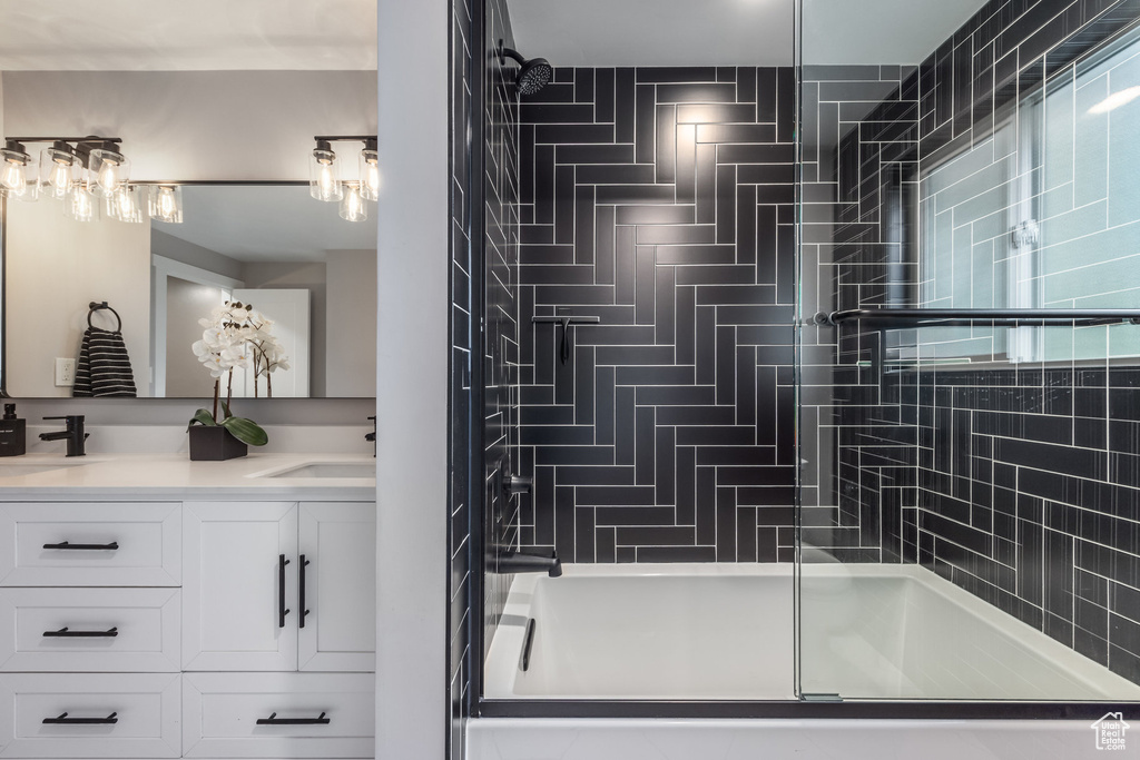 Full bath featuring an enclosed shower and double vanity