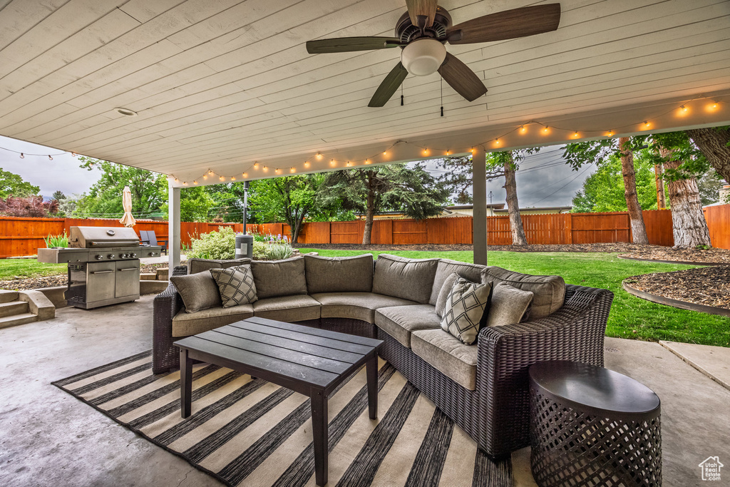 View of patio featuring area for grilling, an outdoor hangout area, and ceiling fan