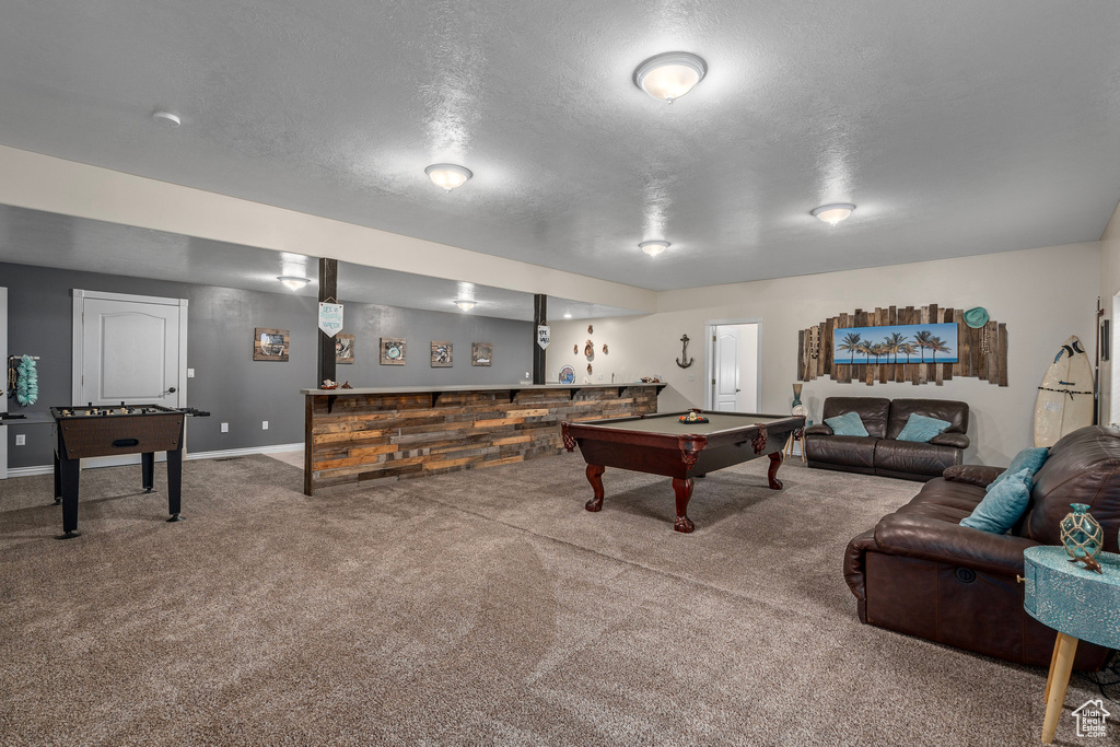 Playroom featuring billiards table, carpet, a textured ceiling, and baseboards