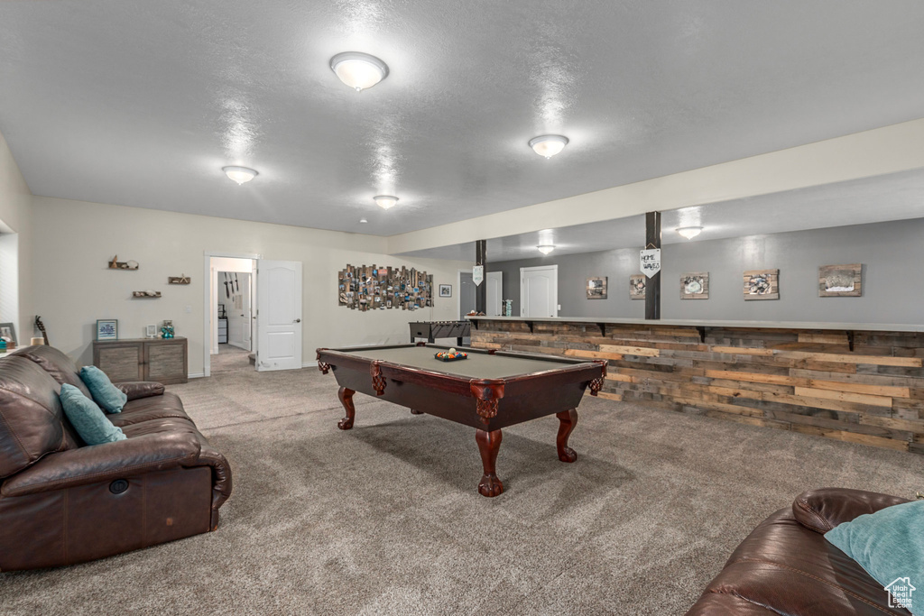 Playroom featuring carpet, billiards, and a textured ceiling