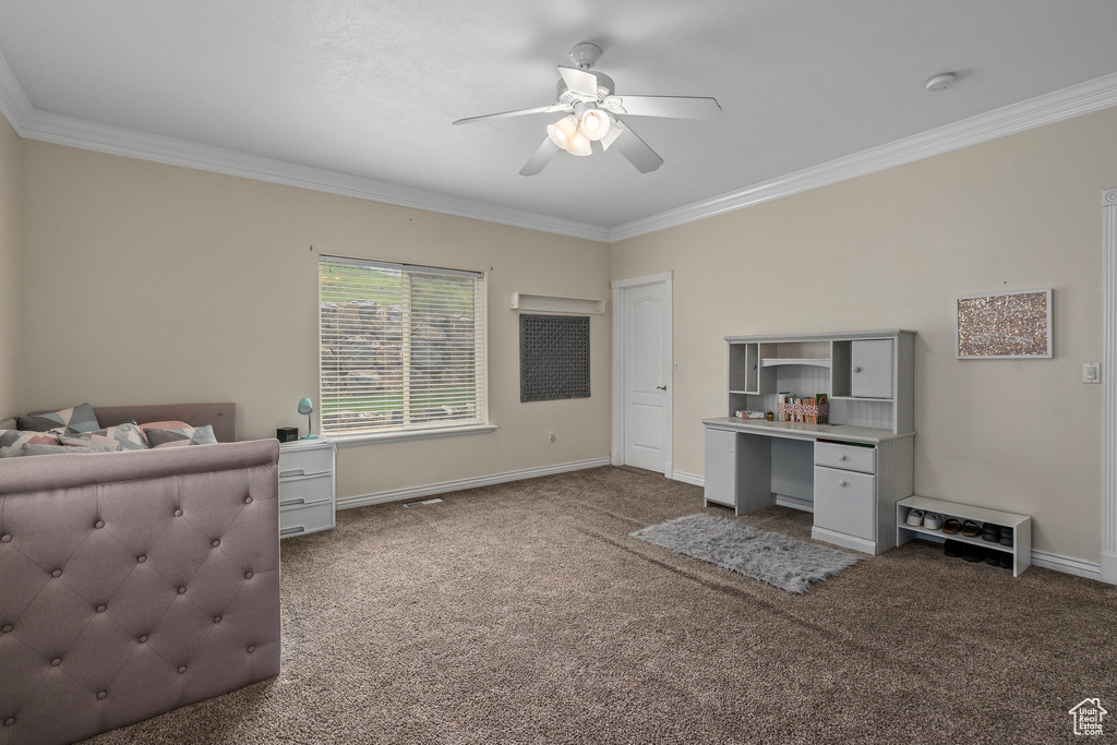 Carpeted bedroom with ornamental molding, baseboards, an office area, and a ceiling fan
