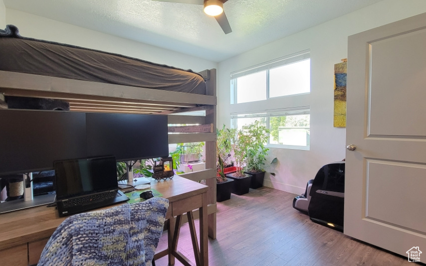 Bedroom with wood finished floors and baseboards