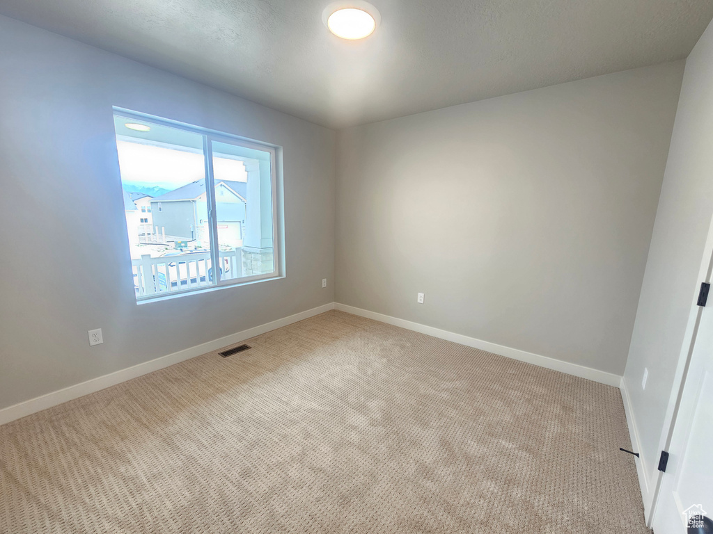 Spare room with carpet floors and baseboards