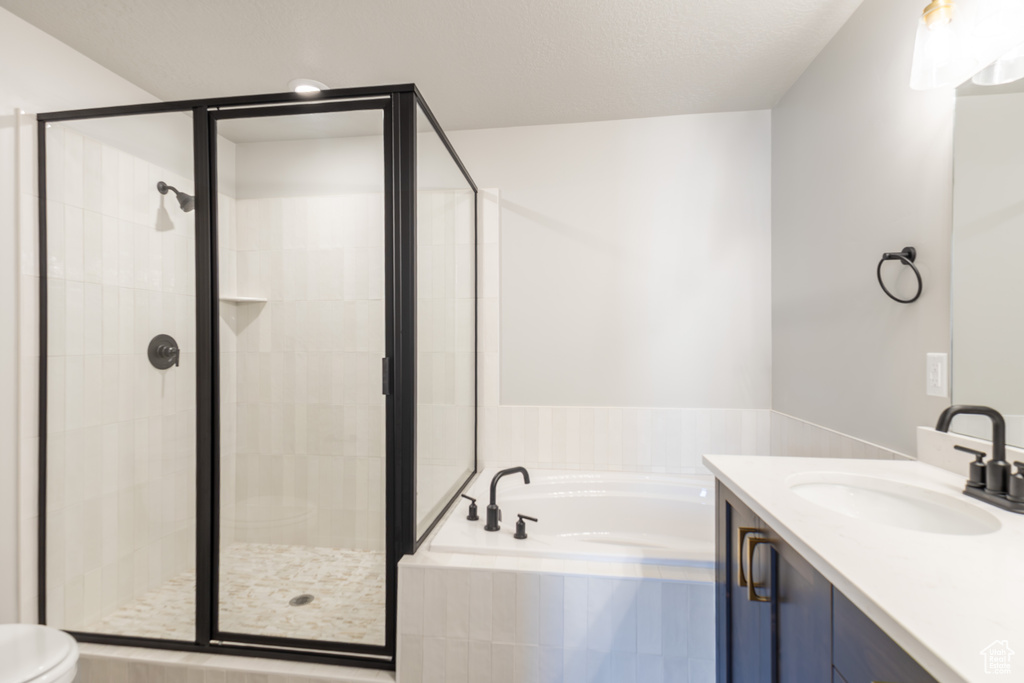 Bathroom with a bath, vanity, and a shower stall