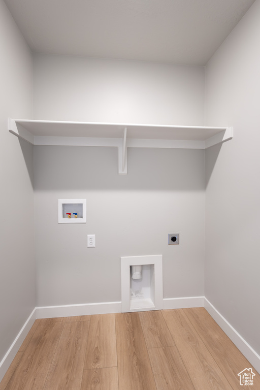 Laundry room featuring electric dryer hookup, wood finished floors, and washer hookup