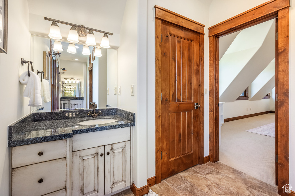 Bathroom featuring baseboards and vanity