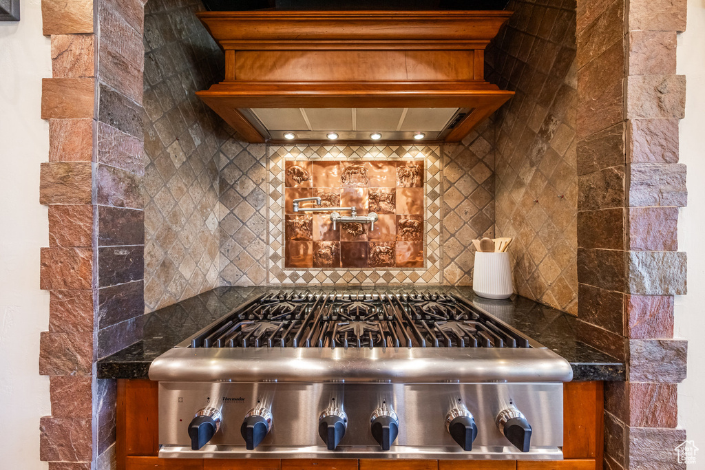 Detailed view of decorative backsplash and custom exhaust hood