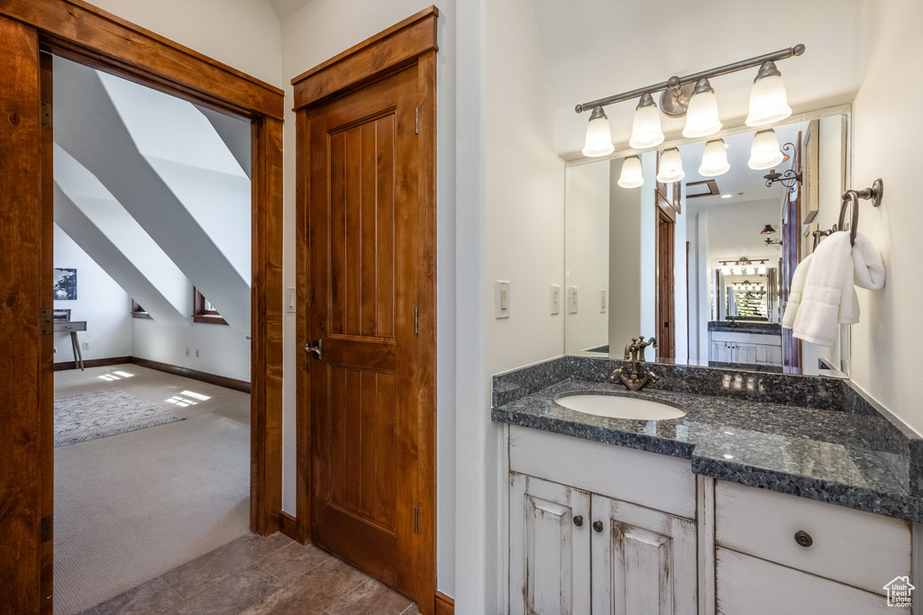 Bathroom featuring vanity and baseboards