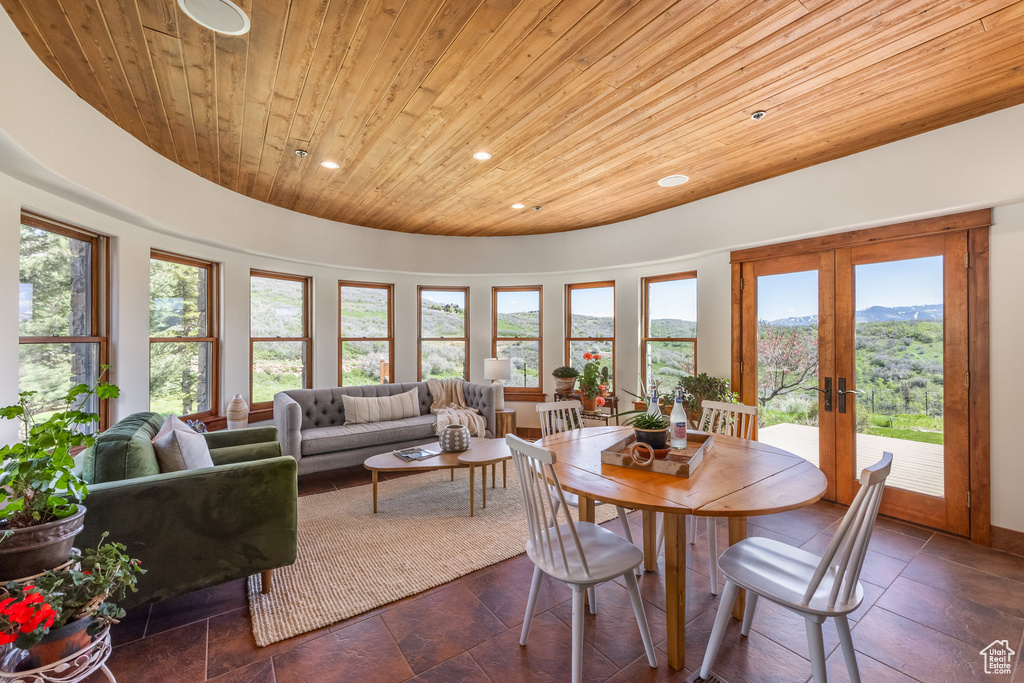 Dining area with wooden ceiling, recessed lighting, french doors, plenty of natural light, and a mountain view