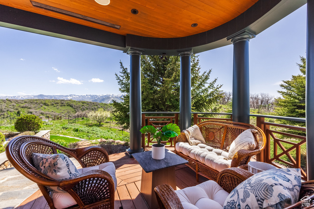 Wooden deck with a mountain view and an outdoor hangout area