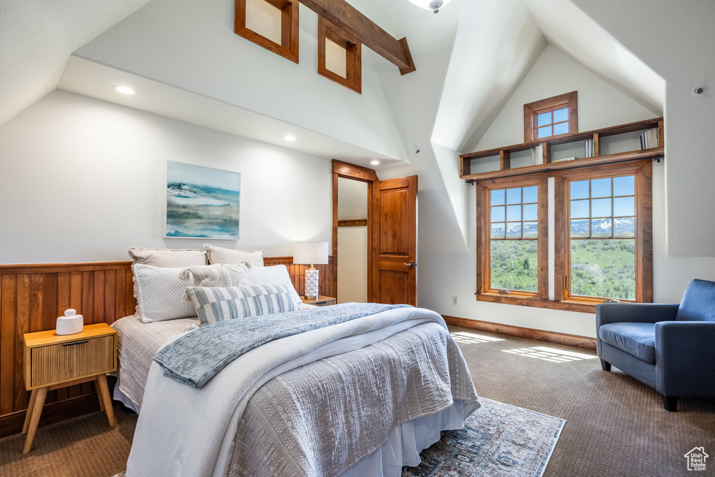 Carpeted bedroom featuring vaulted ceiling, recessed lighting, a wainscoted wall, and wood walls