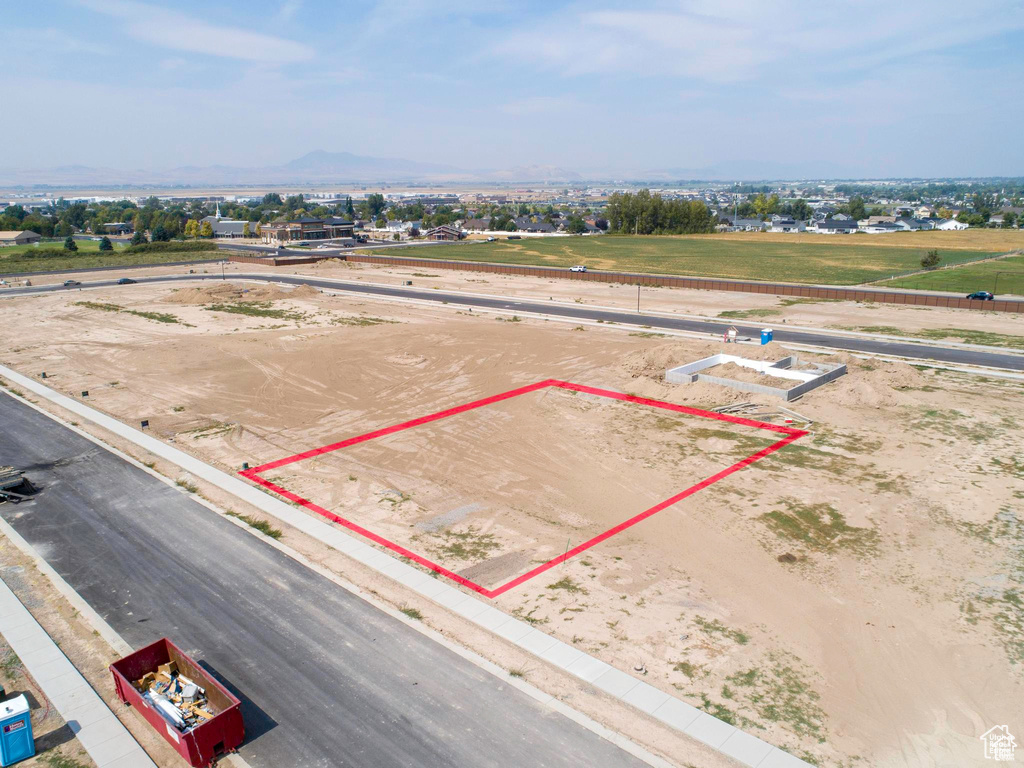 Aerial overview of property's location featuring property parcel outlined and a mountainous background