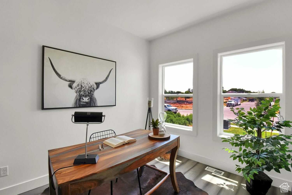 Home office with baseboards and wood finished floors