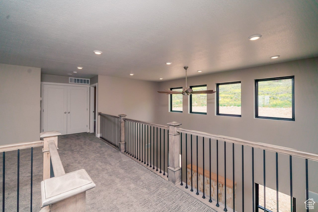 Corridor with carpet, recessed lighting, and an upstairs landing