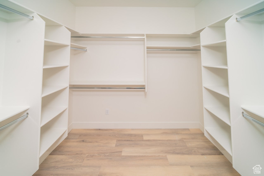 Spacious closet with light wood finished floors