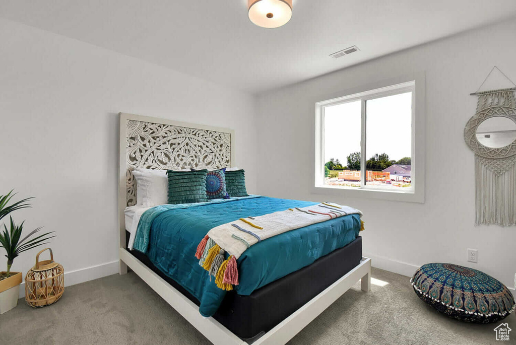 Carpeted bedroom featuring baseboards