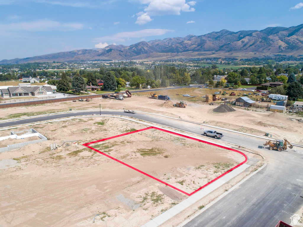 Aerial overview of property\'s location featuring property boundaries highlighted and a mountainous background