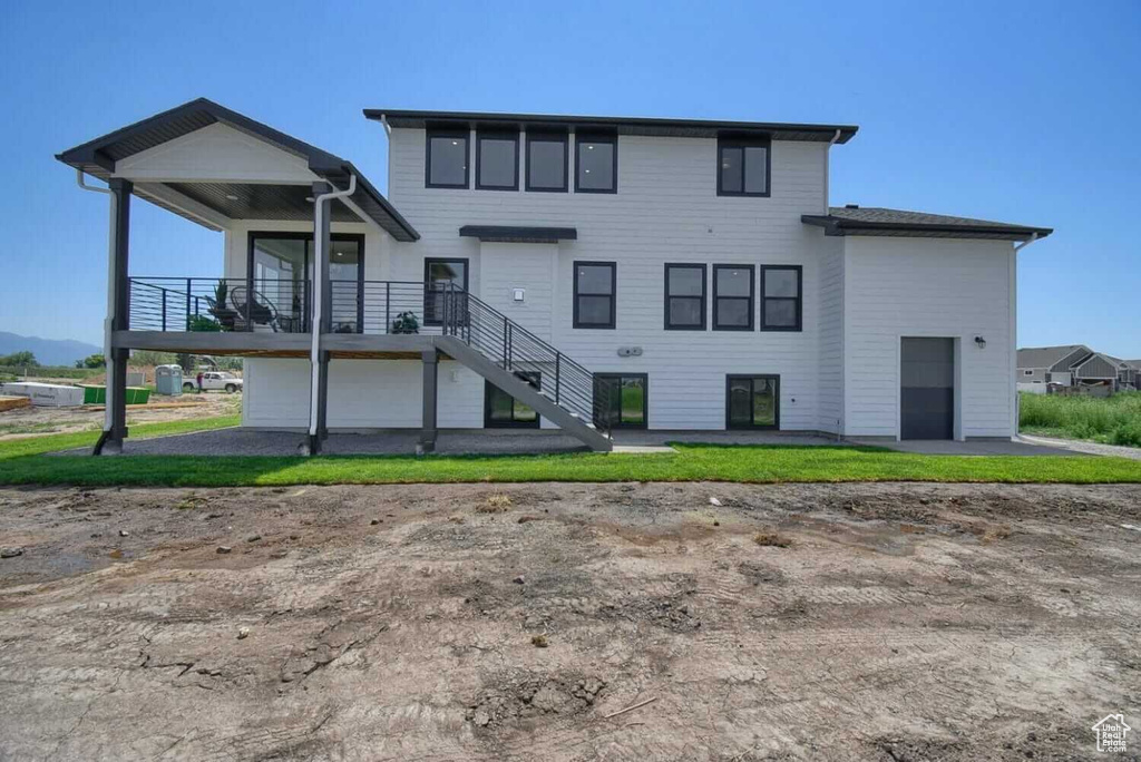 Rear view of house featuring stairway