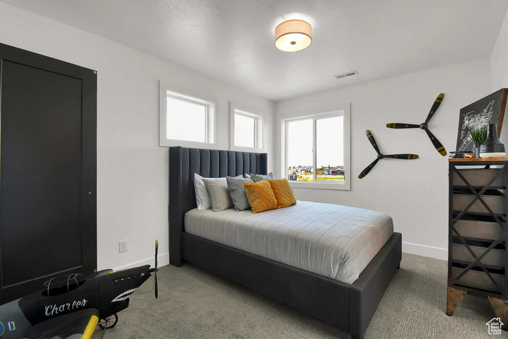 Carpeted bedroom featuring baseboards
