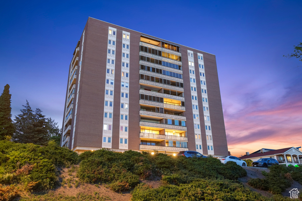 View of property at dusk