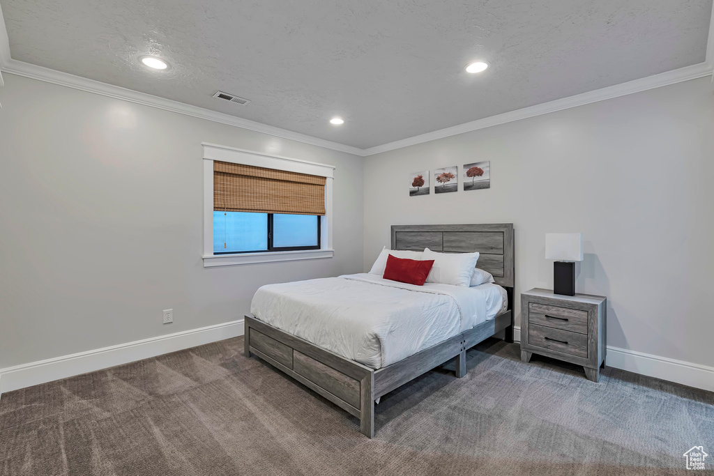 Bedroom featuring baseboards, carpet floors, recessed lighting, and crown molding