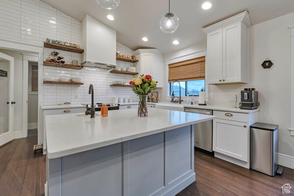 Kitchen with open shelves, dishwasher, a sink, light countertops, and backsplash