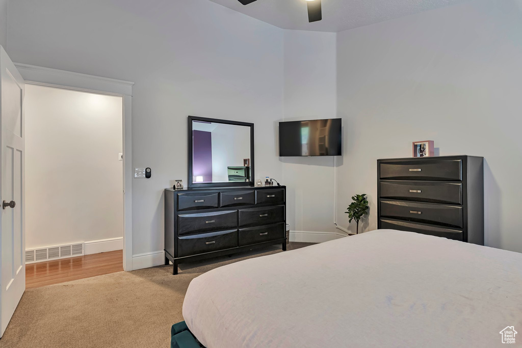 Carpeted bedroom featuring baseboards and ceiling fan