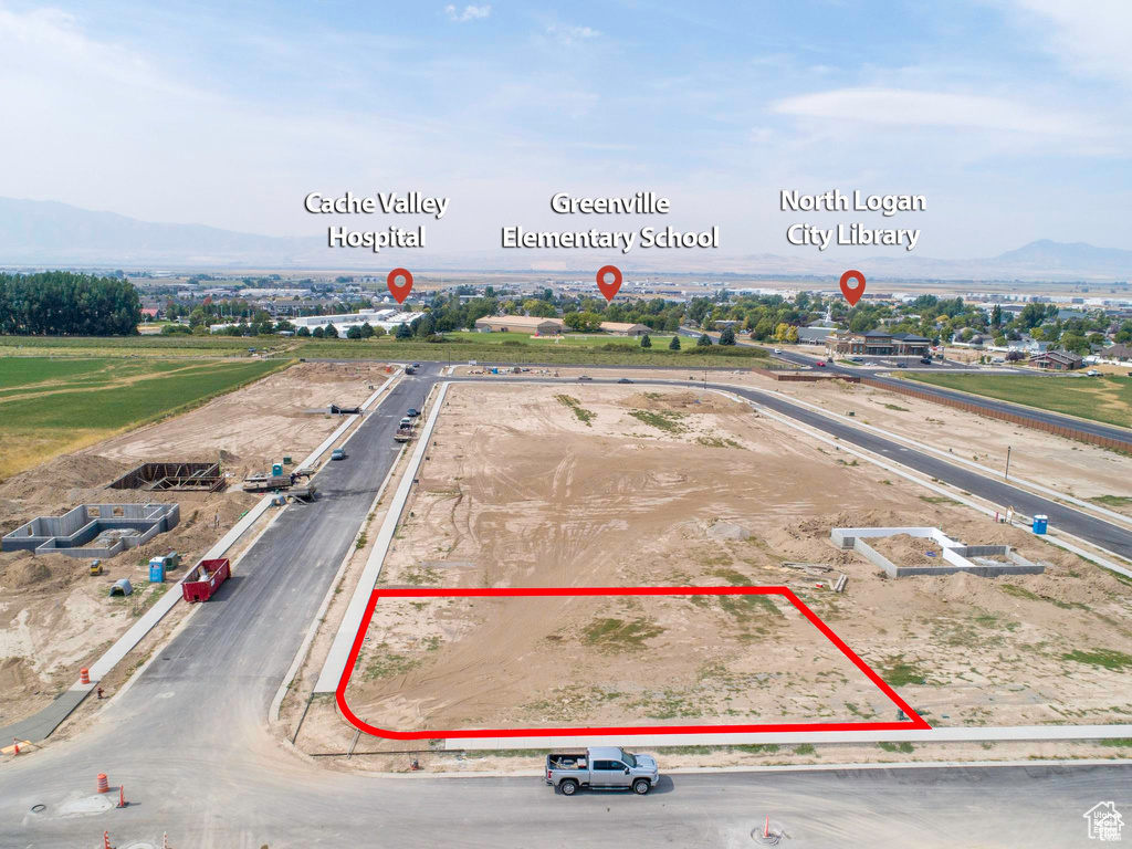 Aerial view of property and surrounding area featuring property boundaries highlighted and mountains