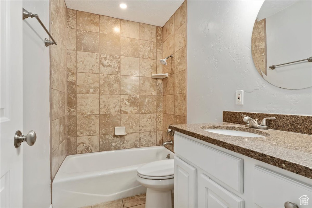 Bathroom with toilet, vanity, and shower / tub combination