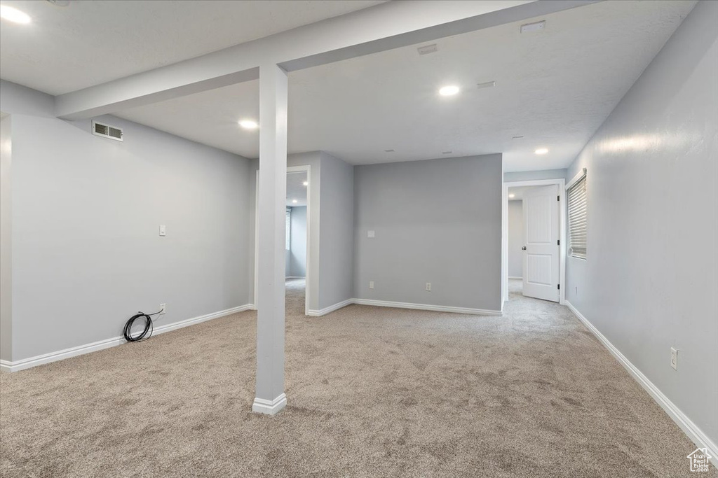 Finished below grade area featuring carpet floors, baseboards, and recessed lighting