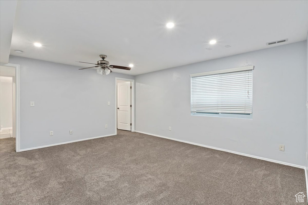 Carpeted empty room with baseboards, recessed lighting, and a ceiling fan