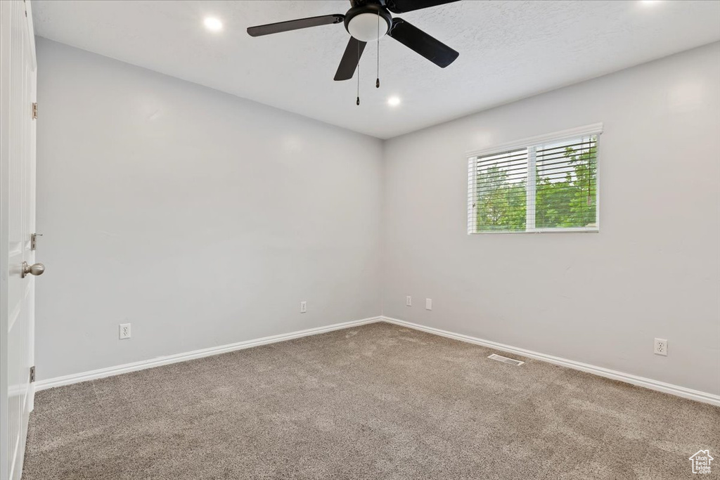 Spare room featuring carpet, a ceiling fan, baseboards, and recessed lighting