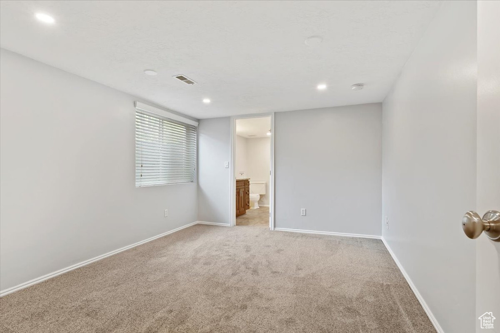 Unfurnished room featuring light carpet, baseboards, recessed lighting, and a smoke detector