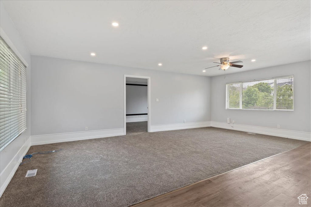Empty room featuring recessed lighting, a ceiling fan, baseboards, and wood finished floors