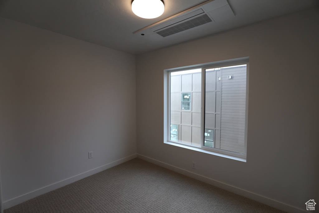 Empty room featuring baseboards and carpet floors