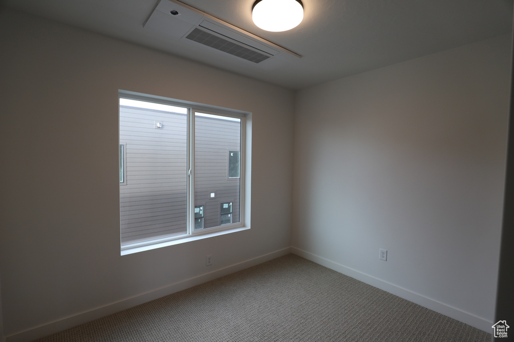 Carpeted empty room with baseboards and plenty of natural light