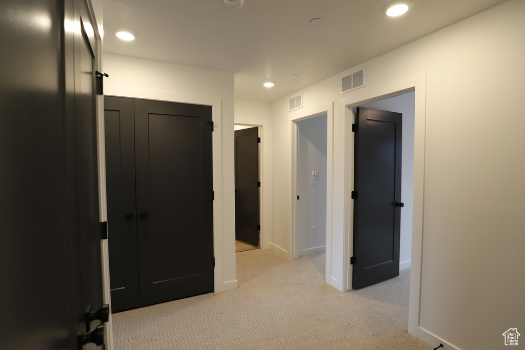 Corridor featuring light carpet, recessed lighting, and baseboards