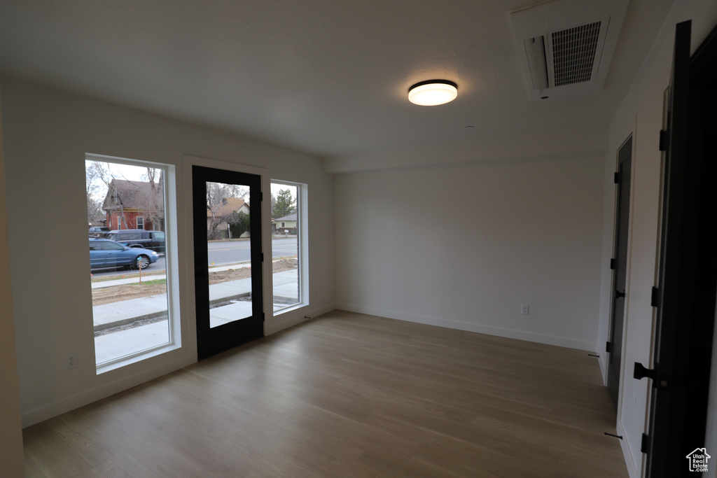 Empty room with wood finished floors and baseboards